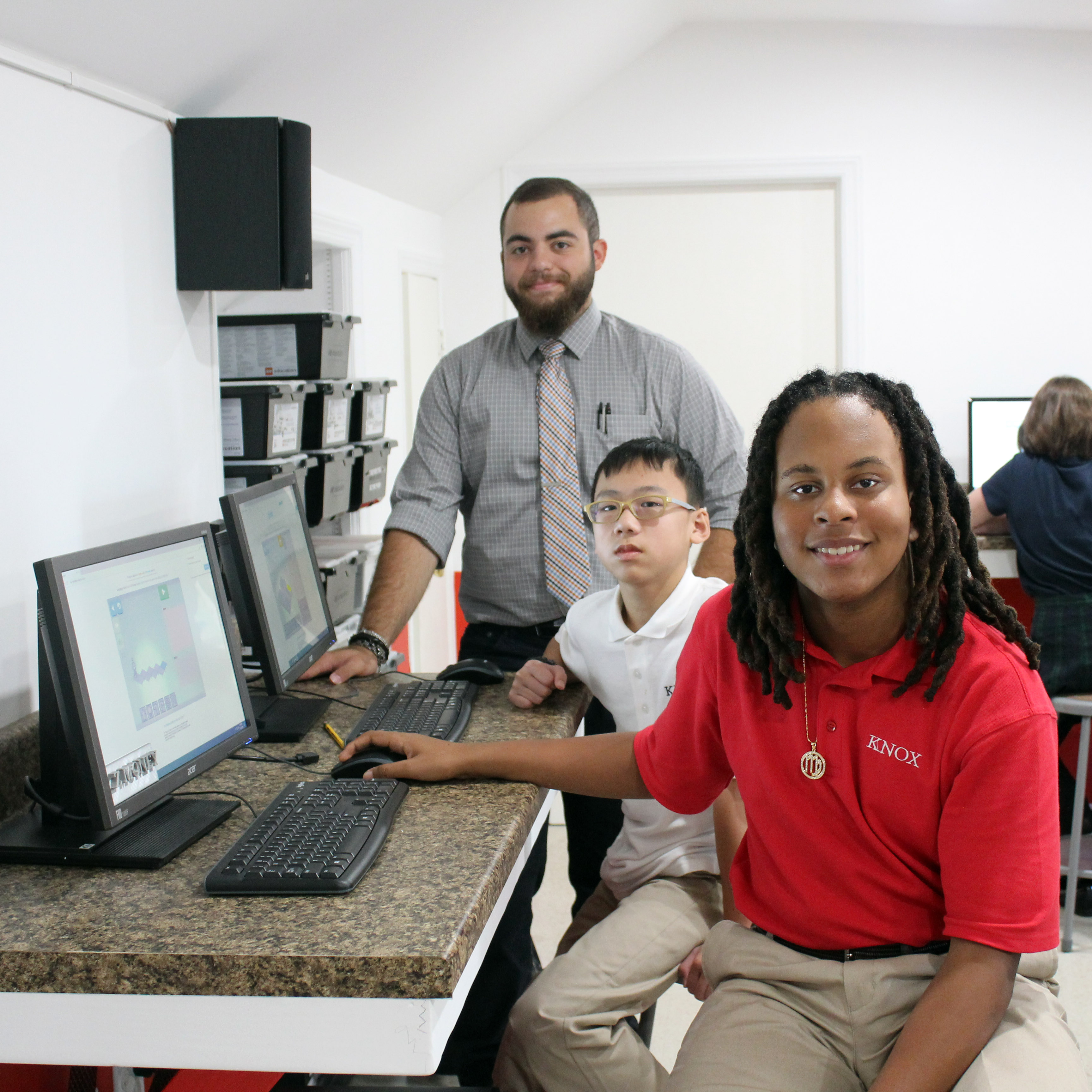Image of STEM Teacher Angelo Mauro with two students